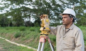 Topographic survey rural land - ALTA SURVEY Arkansas Surveyor using a total station during a topographic survey on rural land