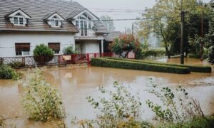 Flooded residential home and yard, illustrating the importance of a flood elevation survey